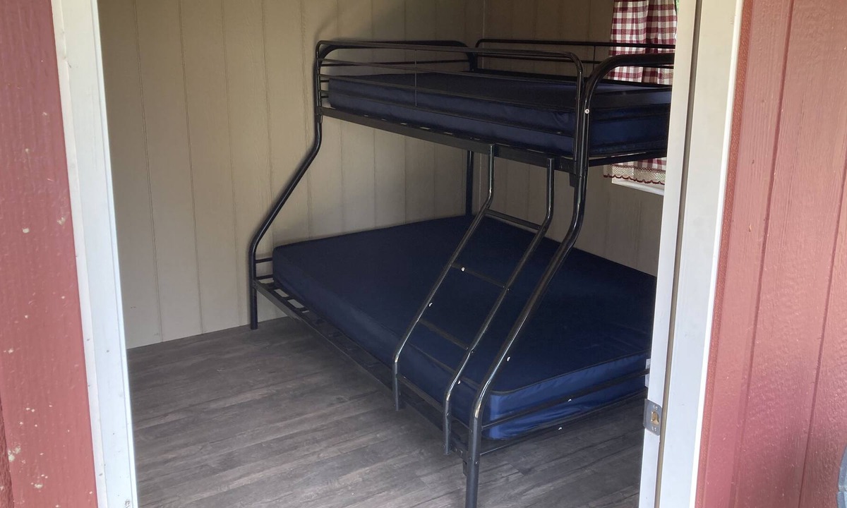Front of Yonge RV Rental | Cozy solar Bunkie cabin located happy green acres campground