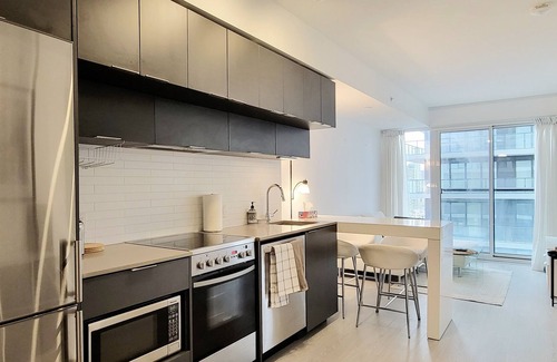 Garden District Condo | Modern 1+1 Bedroom Condo Steps Away from Vibrant Dundas Square