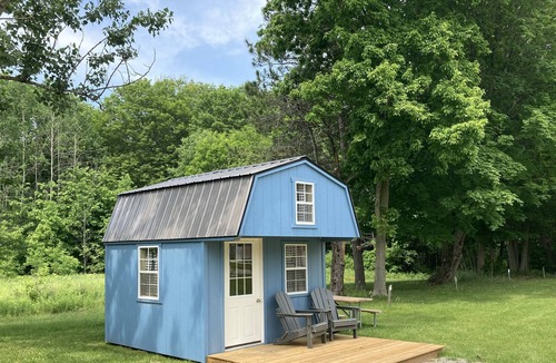 Front of Yonge RV Rental | Cozy solar bunkie cabin located happy green acres campground