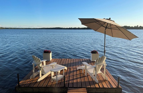 Rideau Lakes Cottage | Glamping anyone? Enjoy picturesque sunsets from your own water’s edge deck!
