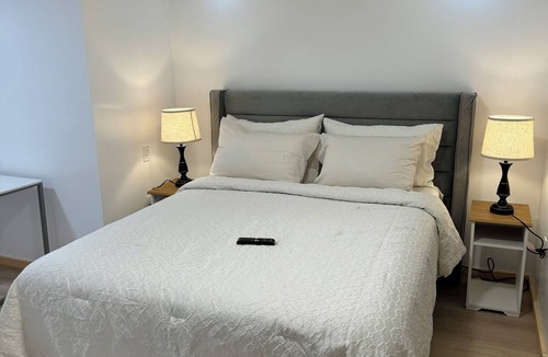 Ottawa Division House | Large bedroom with private bathroom and workspace.