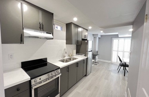 Meadowvale Village House | One bedroom ensuite toilet on main level & kitchen, living, bathroom lower level