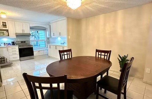 Mississauga Valleys House | Private home with large bedroom and spacious common areas with patio.