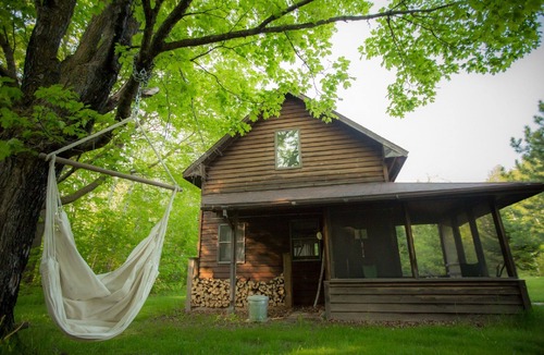 Finlayson Cabin | Spiral Staircase Leads To The Lofted Bedroom And Overlooks The Birch Woods.