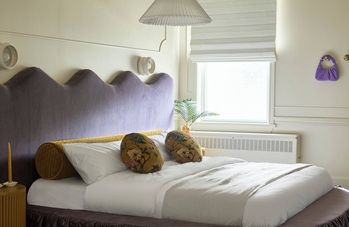 Stratford Hotel | This neutral flat packs a punch with a unique and interesting feature—a round king size bed!
