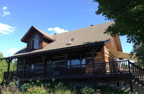 North Algona Wilberforce Cottage | Waterfront log home on Lake Dore. Decks, dock, outdoor hot tub and fire pit.