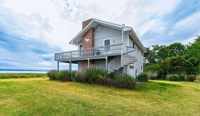 Serene bay front home with a private beach, deck, board games, & washer/dryer