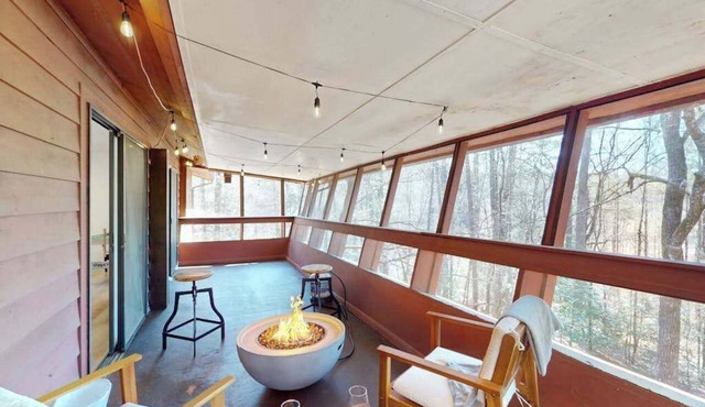 Updated tree-lined cabin with mountain view, and screened-in deck.